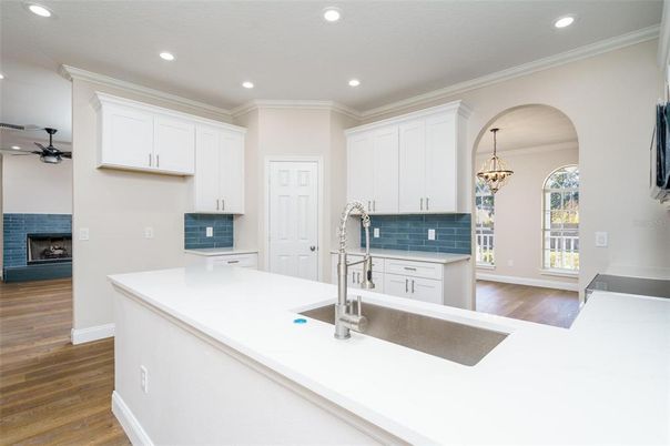 Chandelier, Fireplace, Interior, Kitchen, Recessed Lighting, Wood Texture Flooring