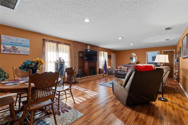 Dining room, Fireplace, Interior, Living room, Recessed Lighting, Wood Texture Flooring