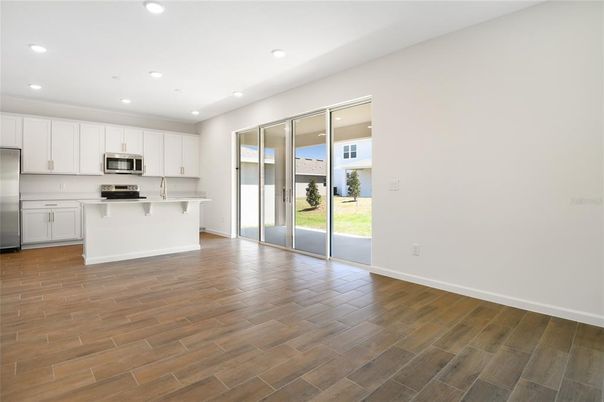 Empty room, Interior, Kitchen, Recessed Lighting, Stainless Steel Appliances, Wood Texture Flooring