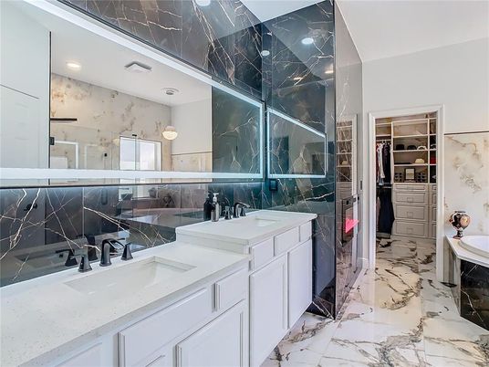 Bathroom, Dual Sink Vanities, Glass Shower, Interior, Marble, Recessed Lighting, Walk-in Closets