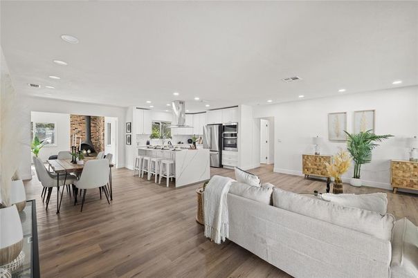 Dining room, Fireplace, Interior, Kitchen, Living room, Recessed Lighting, Stainless Steel Appliances, Stone Walls, Wood Texture Flooring