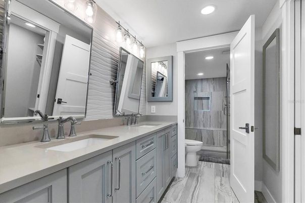 Bathroom, Dual Sink Vanities, Interior, Marble, Recessed Lighting, Wood Texture Flooring