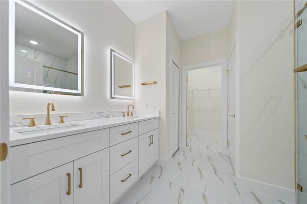 Bathroom, Dual Sink Vanities, Glass Shower, Interior, Marble, Marble Walls, Recessed Lighting