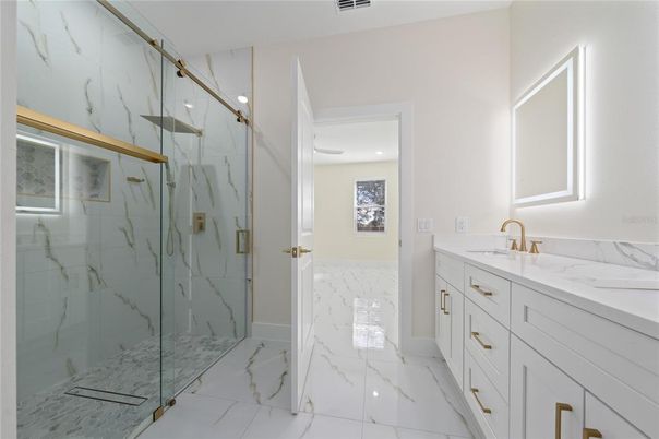 Bathroom, Dual Sink Vanities, Glass Shower, Interior, Marble, Marble Walls, Recessed Lighting