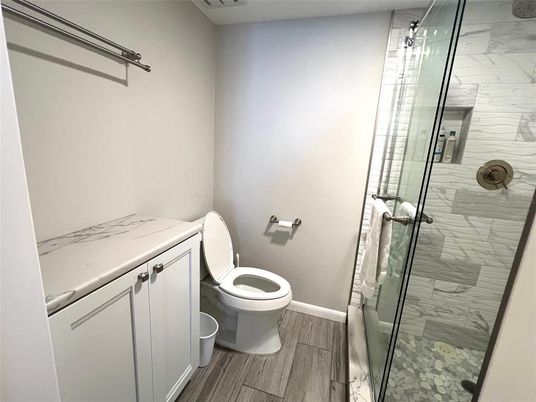 Bathroom, Glass Shower, Interior, Marble Walls, Wood Texture Flooring