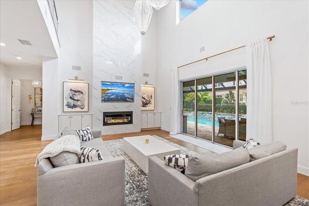 Fireplace, Interior, Living room, Marble Walls, Recessed Lighting, Wood Texture Flooring