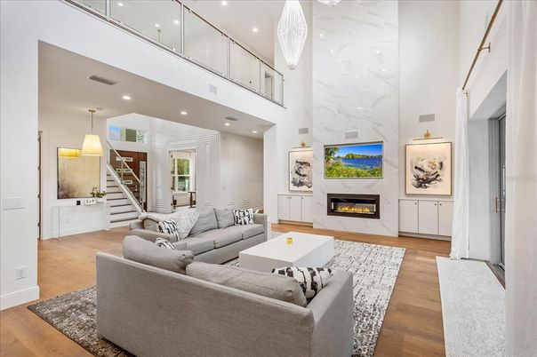 Fireplace, Interior, Living room, Marble Walls, Pendant Lights, Recessed Lighting, Wood Texture Flooring