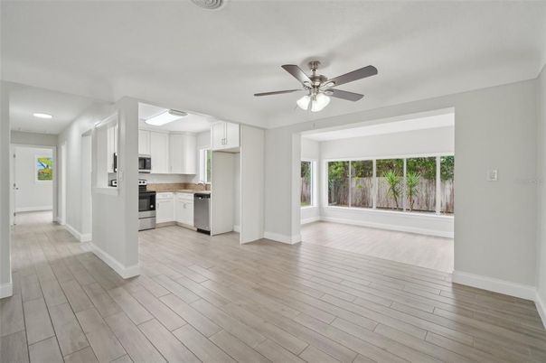 Empty room, Interior, Kitchen, Recessed Lighting, Stainless Steel Appliances, Wood Texture Flooring