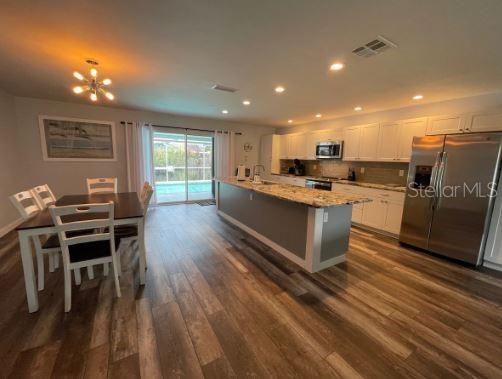 Dining room, Interior, Kitchen, Pendant Lights, Recessed Lighting, Stainless Steel Appliances, Wood Texture Flooring