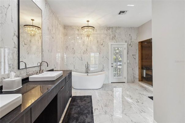 Bathroom, Chandelier, Dual Sink Vanities, Free Standing Baths, Interior, Marble, Marble Walls