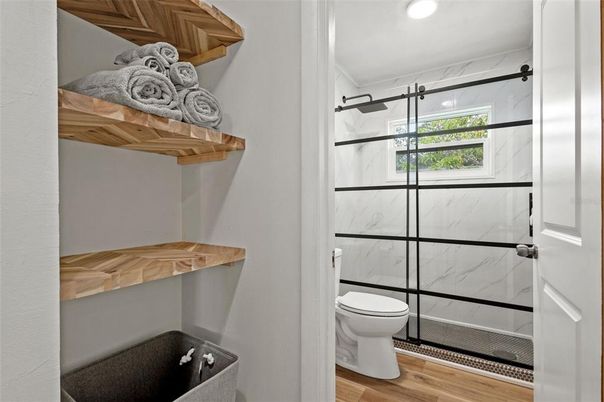 Bathroom, Glass Shower, Interior, Marble Walls, Recessed Lighting, Wood Texture Flooring
