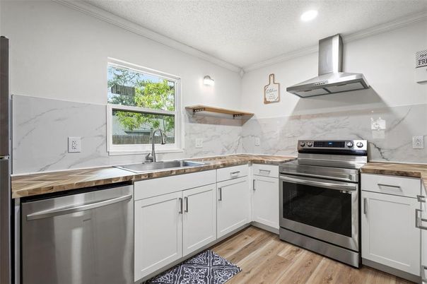 Interior, Kitchen, Marble Walls, Recessed Lighting, Stainless Steel Appliances, Wood Texture Flooring