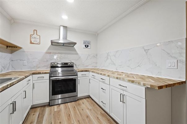 Interior, Kitchen, Marble Walls, Recessed Lighting, Stainless Steel Appliances, Wood Texture Flooring