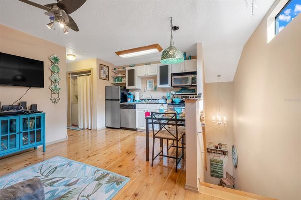 Chandelier, Dining room, Interior, Kitchen, Pendant Lights, Stainless Steel Appliances, Wood Texture Flooring
