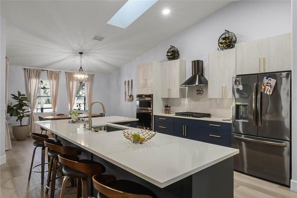 Chandelier, Dining room, Interior, Kitchen, Pendant Lights, Recessed Lighting, Stainless Steel Appliances, Wood Texture Flooring