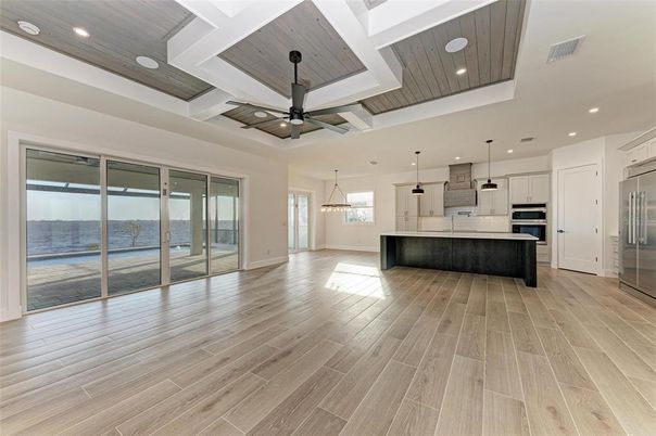 Empty room, Interior, Kitchen, Pendant Lights, Recessed Lighting, Stainless Steel Appliances, Water, Wood Texture Flooring