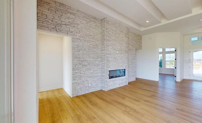 Empty room, Fireplace, Interior, Recessed Lighting, Stone Walls, Wood Texture Flooring