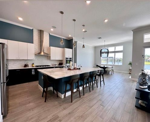 Dining room, Interior, Kitchen, Pendant Lights, Recessed Lighting, Stainless Steel Appliances, Wood Texture Flooring