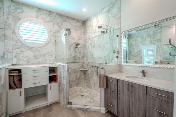 Bathroom, Dual Sink Vanities, Glass Shower, Interior, Marble, Marble Walls, Recessed Lighting, Wood Texture Flooring