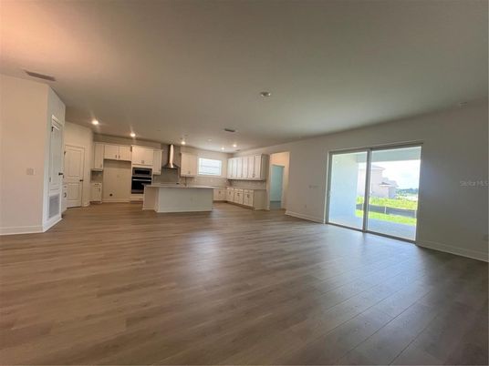 Empty room, Interior, Kitchen, Pendant Lights, Recessed Lighting, Stainless Steel Appliances, Wood Texture Flooring