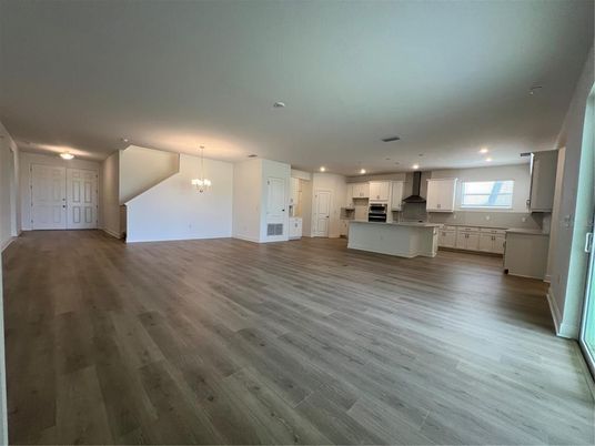 Chandelier, Empty room, Interior, Kitchen, Pendant Lights, Recessed Lighting, Stainless Steel Appliances, Wood Texture Flooring