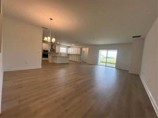 Chandelier, Empty room, Interior, Kitchen, Pendant Lights, Recessed Lighting, Stainless Steel Appliances, Wood Texture Flooring