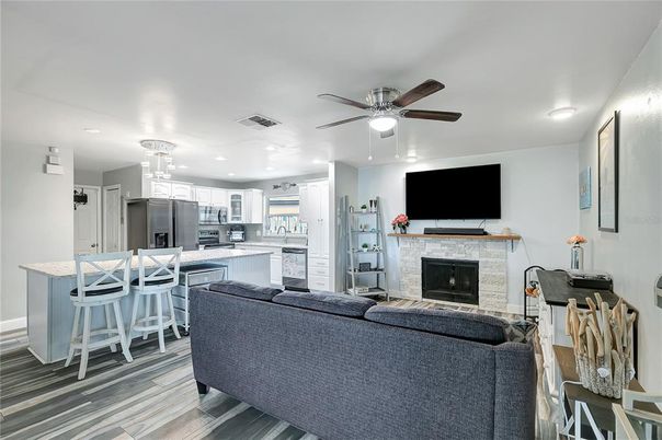 Fireplace, Interior, Kitchen, Living room, Pendant Lights, Recessed Lighting, Stainless Steel Appliances, Wood Texture Flooring
