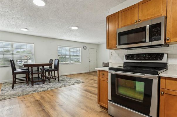 Dining room, Interior, Kitchen, Recessed Lighting, Stainless Steel Appliances, Wood Texture Flooring