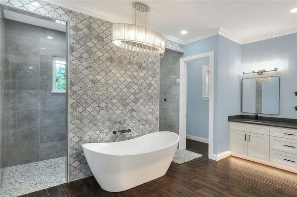 Bathroom, Chandelier, Free Standing Baths, Glass Shower, Interior, Pendant Lights, Recessed Lighting, Wood Texture Flooring