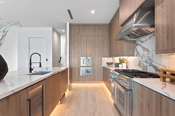 Interior, Kitchen, Marble Walls, Recessed Lighting, Stainless Steel Appliances, Wood Texture Flooring