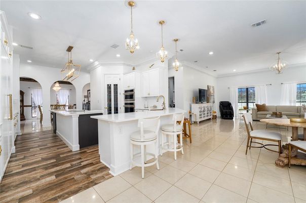 Chandelier, Dining room, Interior, Kitchen, Living room, Pendant Lights, Recessed Lighting, Stainless Steel Appliances, Wood Texture Flooring