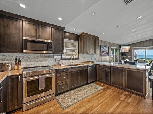 Dining room, Interior, Kitchen, Recessed Lighting, Stainless Steel Appliances, Water, Wood Texture Flooring
