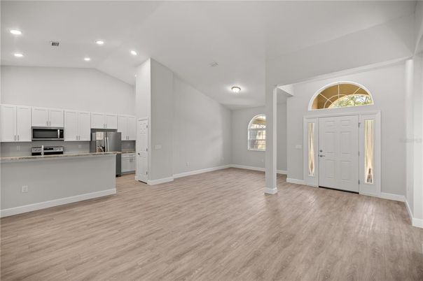 Empty room, Interior, Kitchen, Recessed Lighting, Stainless Steel Appliances, Wood Texture Flooring