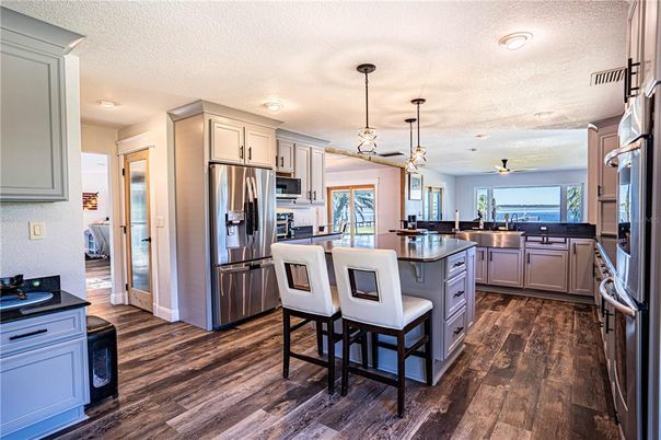 Dining room, Interior, Kitchen, Pendant Lights, Recessed Lighting, Stainless Steel Appliances, Wood Texture Flooring