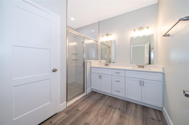 Bathroom, Dual Sink Vanities, Glass Shower, Interior, Recessed Lighting, Wood Texture Flooring