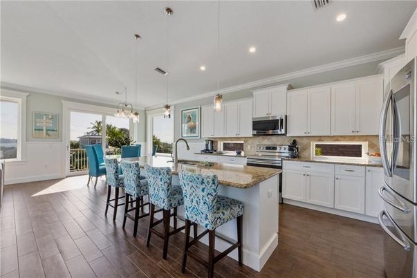 Dining room, Interior, Kitchen, Pendant Lights, Recessed Lighting, Stainless Steel Appliances, Wood Texture Flooring