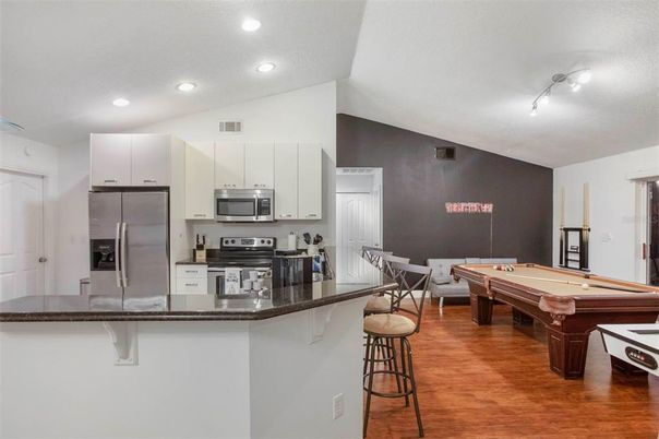 Billiard Table, Dining room, Game Room, Interior, Kitchen, Recessed Lighting, Stainless Steel Appliances, Wood Texture Flooring
