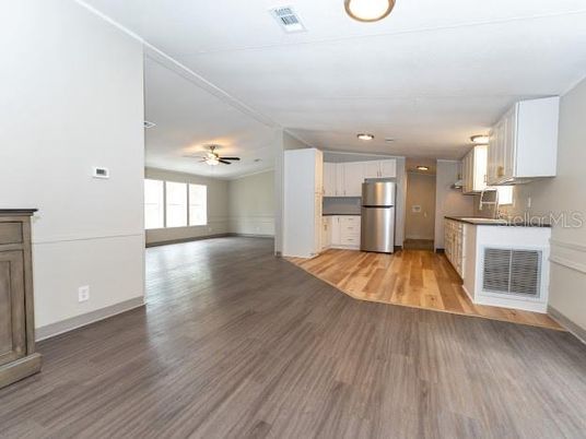 Empty room, Interior, Kitchen, Recessed Lighting, Stainless Steel Appliances, Wood Texture Flooring
