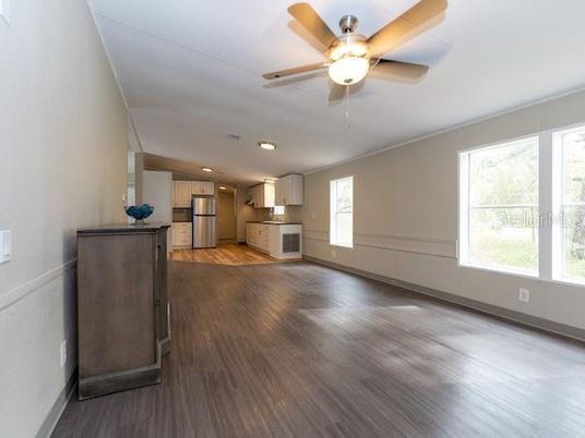 Empty room, Interior, Kitchen, Recessed Lighting, Stainless Steel Appliances, Wood Texture Flooring