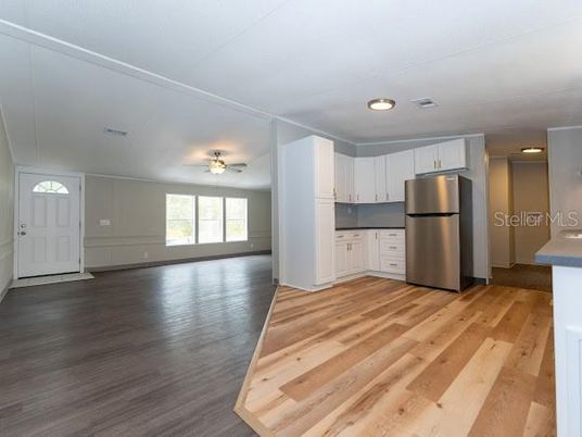 Empty room, Interior, Kitchen, Recessed Lighting, Stainless Steel Appliances, Wood Texture Flooring