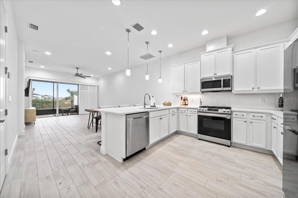 Dining room, Interior, Kitchen, Pendant Lights, Recessed Lighting, Stainless Steel Appliances, Wood Texture Flooring