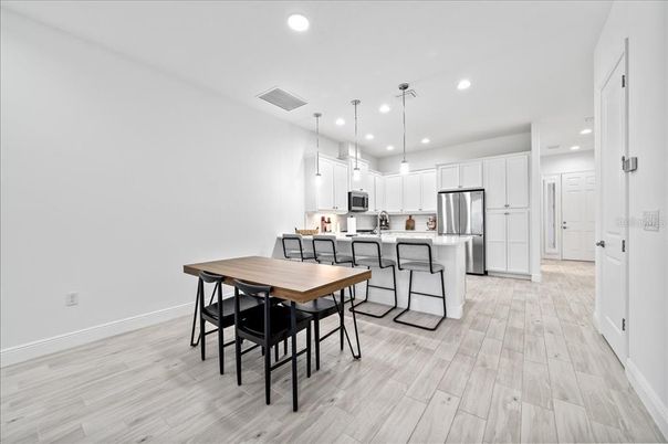 Dining room, Interior, Kitchen, Pendant Lights, Recessed Lighting, Stainless Steel Appliances, Wood Texture Flooring