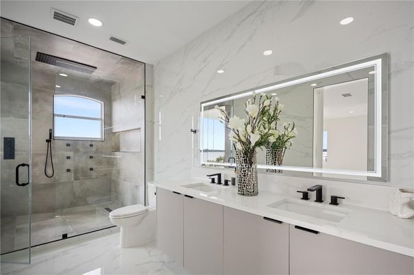 Bathroom, Dual Sink Vanities, Glass Shower, Interior, Marble, Marble Walls, Recessed Lighting