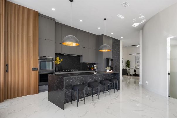 Interior, Kitchen, Marble, Marble Walls, Pendant Lights, Recessed Lighting, Stainless Steel Appliances