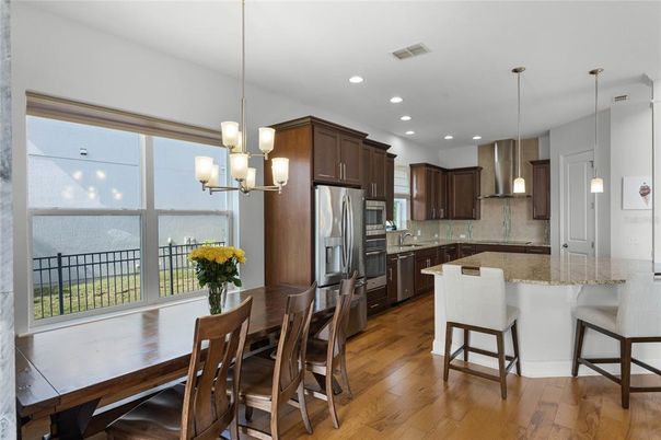 Chandelier, Dining room, Interior, Kitchen, Pendant Lights, Recessed Lighting, Stainless Steel Appliances, Wood Texture Flooring
