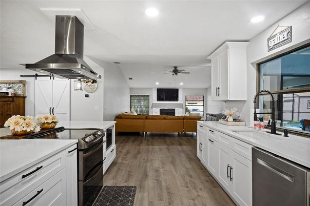 Fireplace, Interior, Kitchen, Living room, Recessed Lighting, Stainless Steel Appliances, Wood Texture Flooring