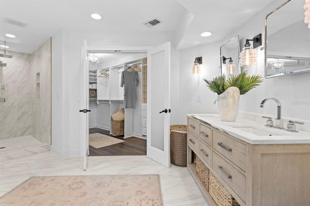 Bathroom, Dual Sink Vanities, Interior, Marble, Marble Walls, Recessed Lighting, Wood Texture Flooring