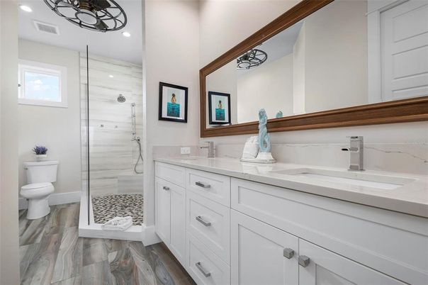 Bathroom, Dual Sink Vanities, Glass Shower, Interior, Recessed Lighting, Wood Texture Flooring