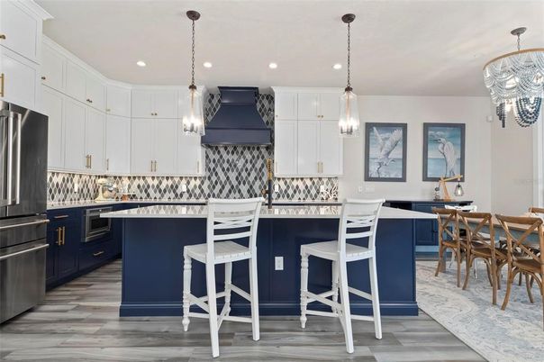 Chandelier, Dining room, Interior, Kitchen, Pendant Lights, Recessed Lighting, Stainless Steel Appliances, Wood Texture Flooring