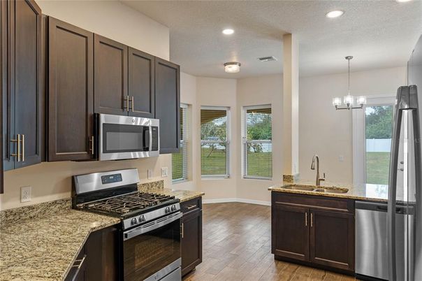 Chandelier, Interior, Kitchen, Pendant Lights, Recessed Lighting, Stainless Steel Appliances, Wood Texture Flooring